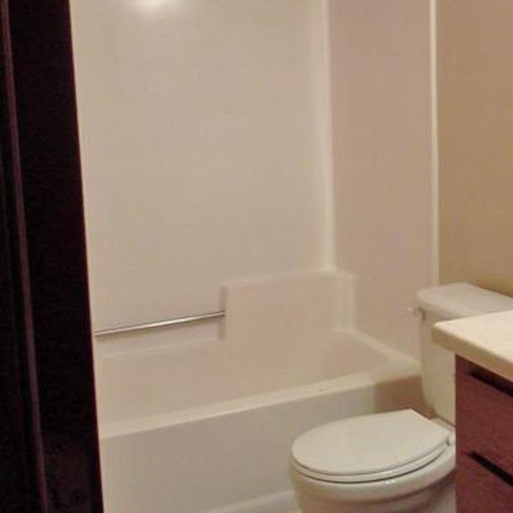 a white toilet sits next to a sink in a bathroom.