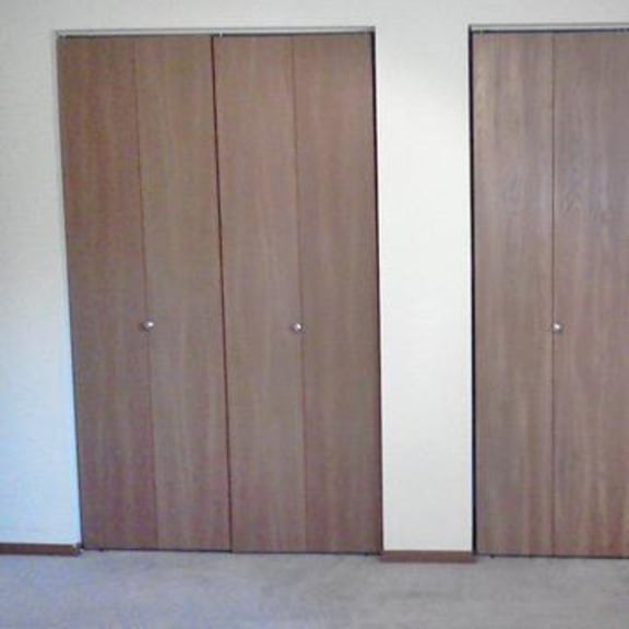 two brown wood doors in a room.
