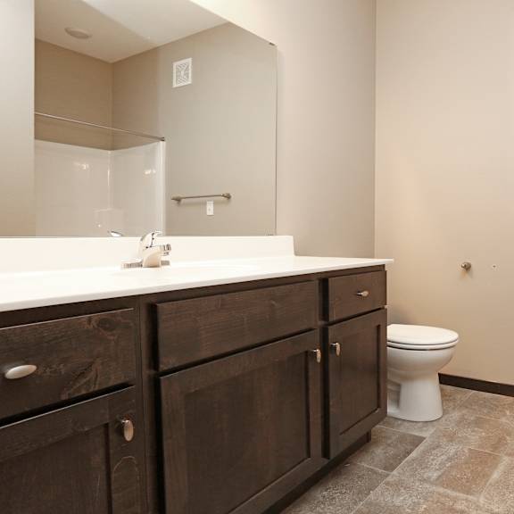 an empty bathroom with a toilet and a sink