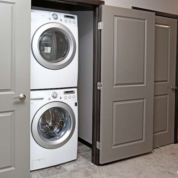 a front loading washer and dryer in a closet