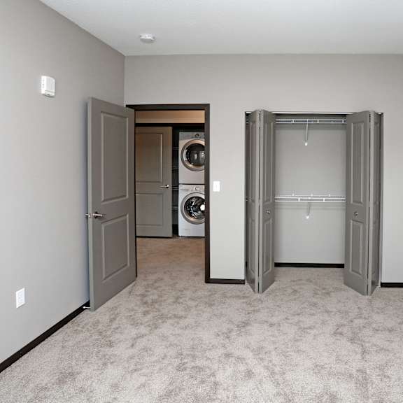 a laundry room with two doors and a washer and dryer