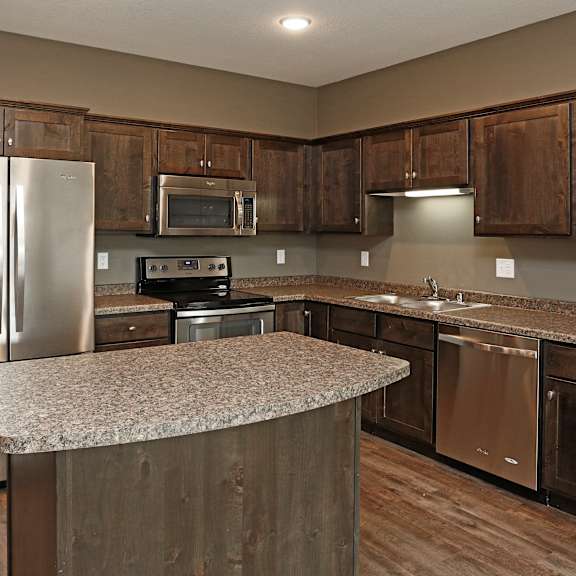 a kitchen with stainless steel appliances and granite counter tops