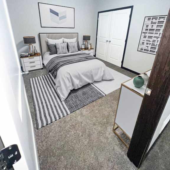 a bedroom with a bed, nightstands, and a dresser.