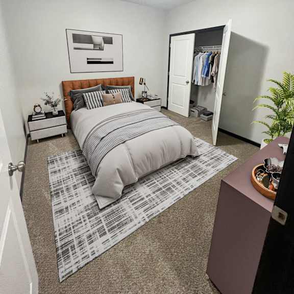 a bedroom with a bed, a dresser, and a plant.