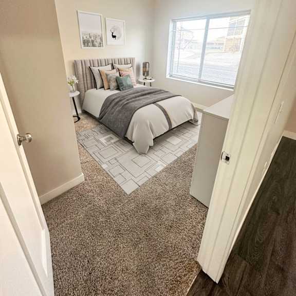 a bedroom with a bed, nightstand, and two pictures on the wall.