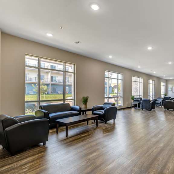 a spacious living room with a variety of seating options and a television.