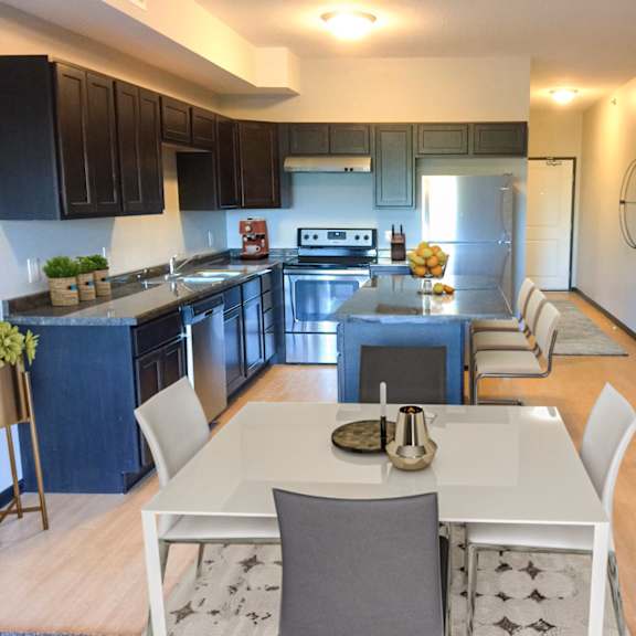 a modern kitchen with a dining table and chairs.