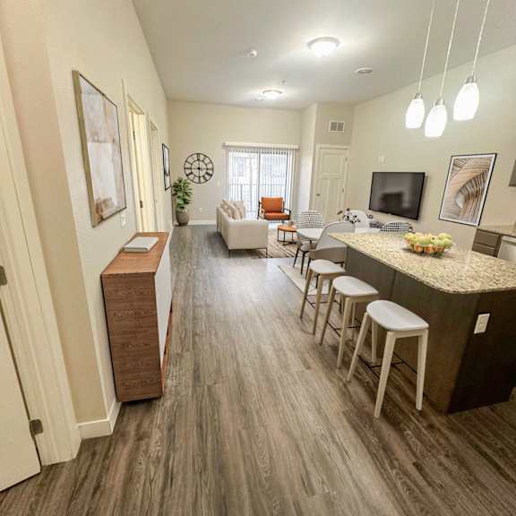 a modern living room with a bar area and a television.