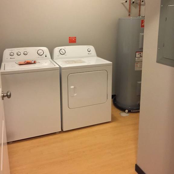 two washing machines in a laundry room.