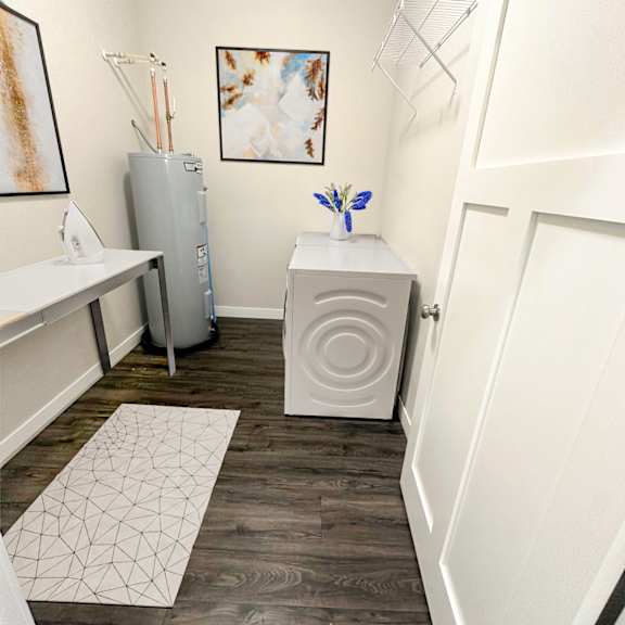 a small room with a white table and a white cabinet.