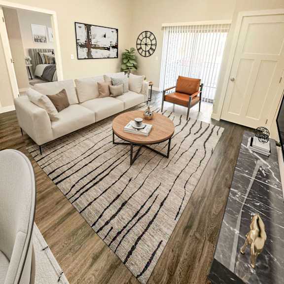 a living room with a white couch, a coffee table, and a rug.