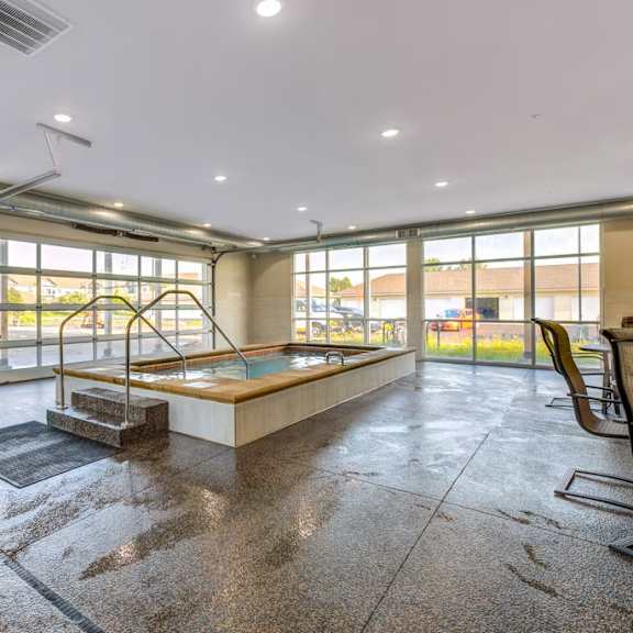 a room with a table, chairs and a pool table.