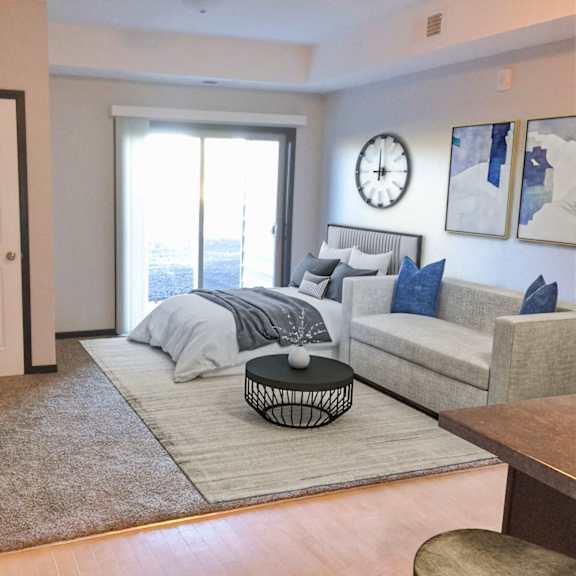 a living room with a grey couch and a large window.