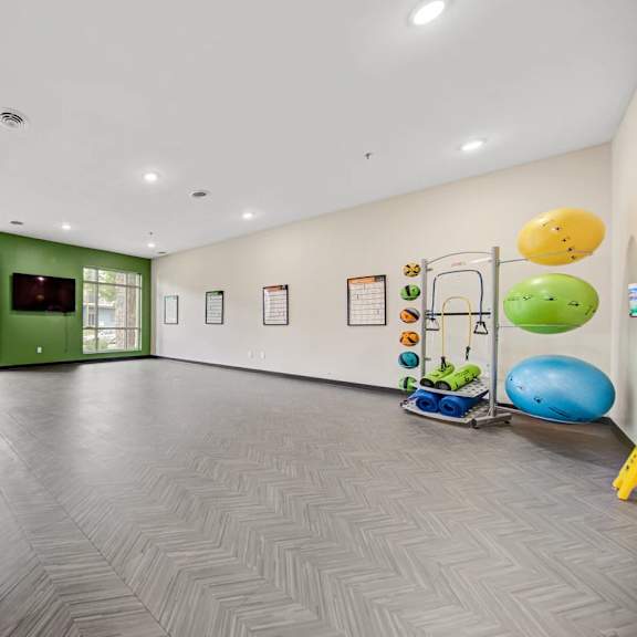 a room with a grey floor and a green wall.