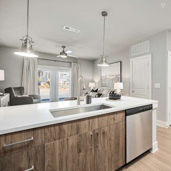Thumbnail 2 of 13 A modern kitchen with wooden cabinets and stainless steel appliances.at The Ashton at East Park Apartments, Kennesaw