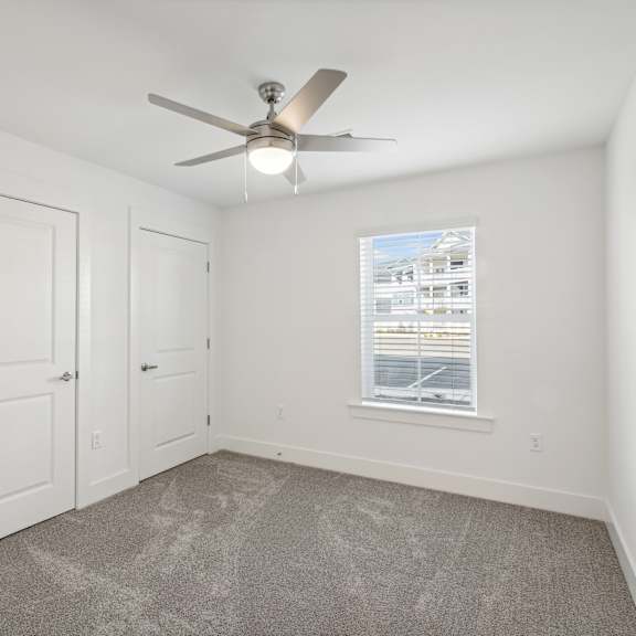 Thumbnail 6 of 7 A room with a ceiling fan and a window with blinds at The Parker North Augusta, North Augusta, SC, 29841