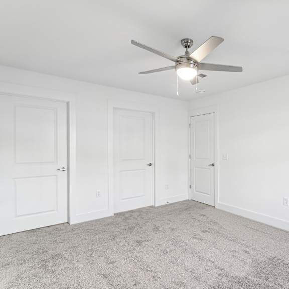 Thumbnail 2 of 7 A room with a ceiling fan and carpeted floor at The Parker North Augusta, North Augusta, SC, 29841