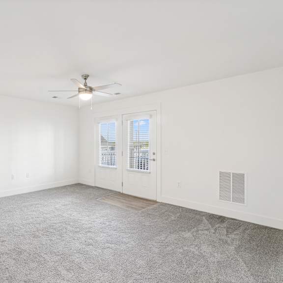 Thumbnail 3 of 7 A room with a ceiling fan and carpeted floor at The Parker North Augusta, North Augusta, SC, 29841