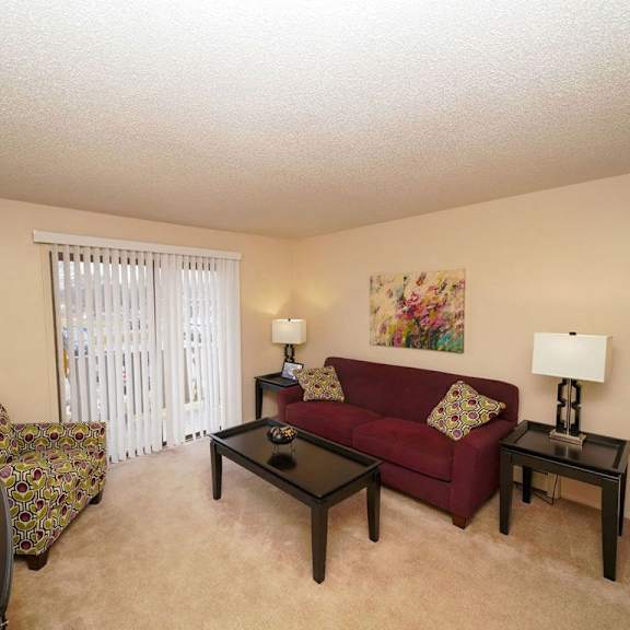 Thumbnail 3 of 7 a living room with a couch and a tv