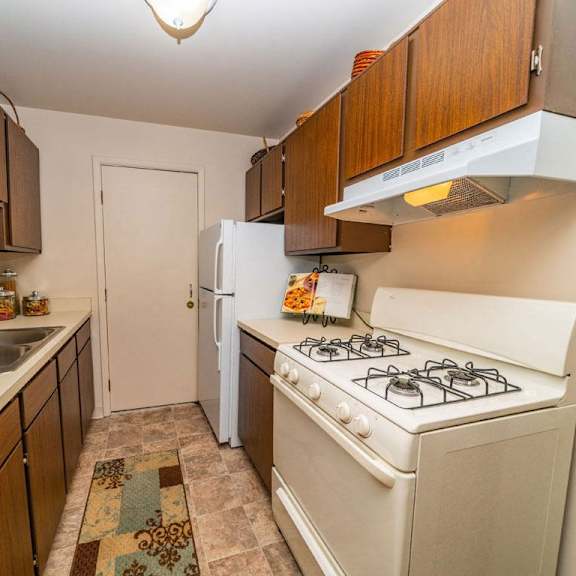Thumbnail 7 of 7 a kitchen with a stove and a refrigerator