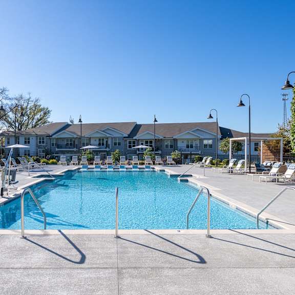 a large swimming pool with a metal fence around it.