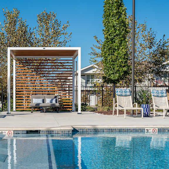 a pool with a slide and a sun shade.