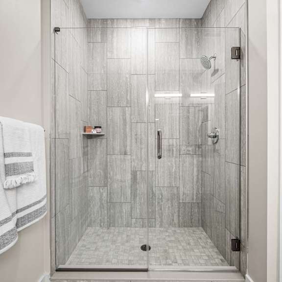 a white bathroom with a walk in shower.