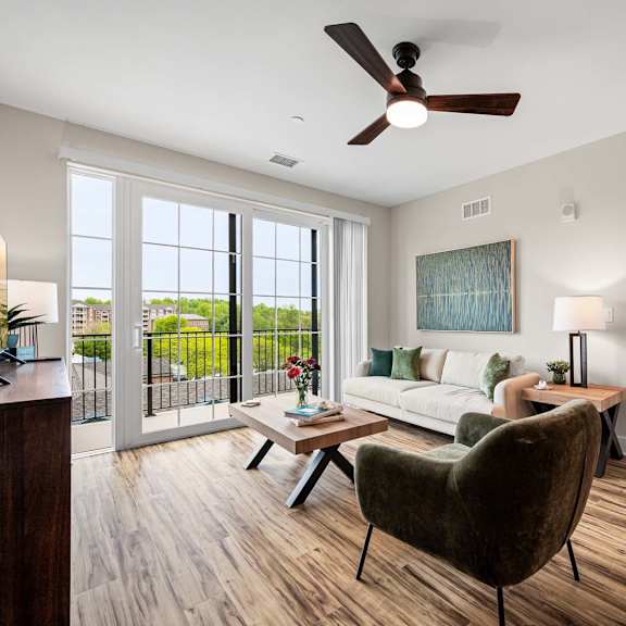 a living room with a brown chair and a painting on the wall.
