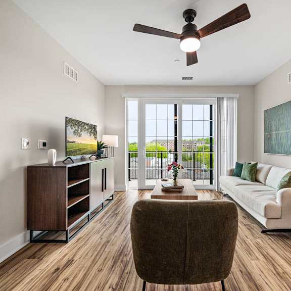 a living room with a brown chair and a white couch.