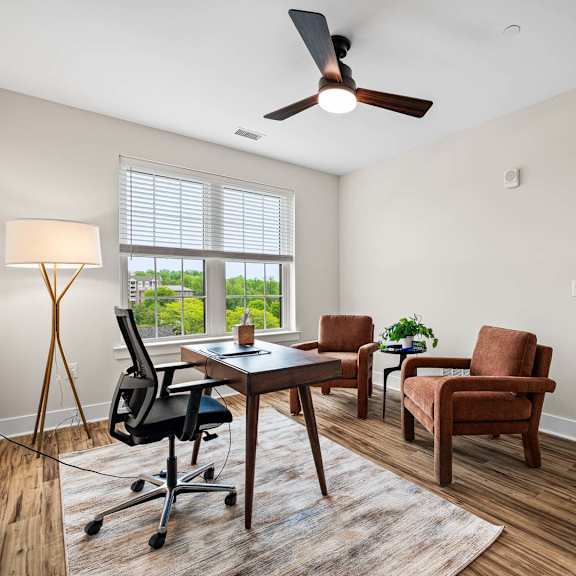 a room with a ceiling fan and a table with chairs.