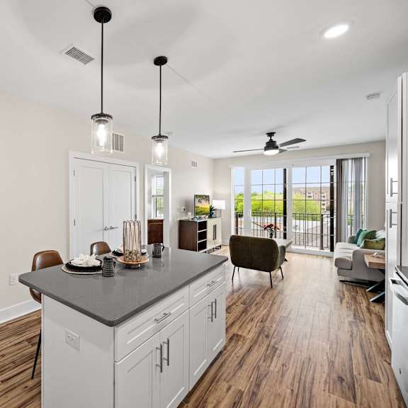 a kitchen with a large island and a dining area.