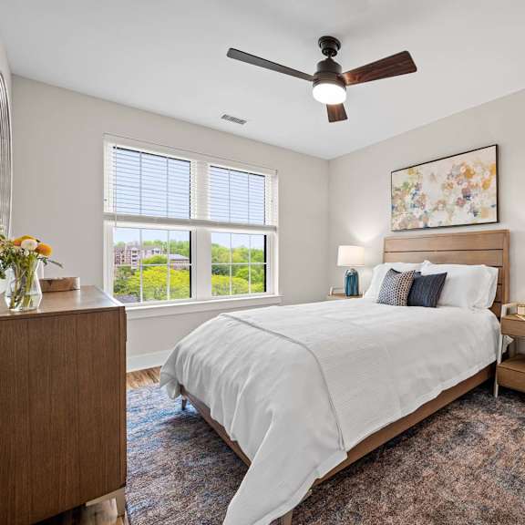 a bedroom with a large bed and a ceiling fan.