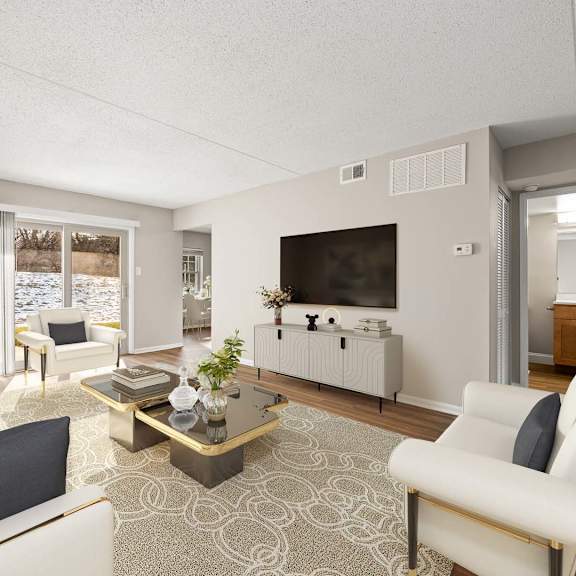 a living room with a white couch, a coffee table, and a television.