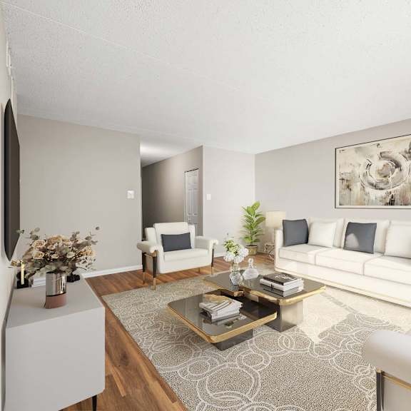 a living room with a white sofa, a coffee table, and a painting on the wall.