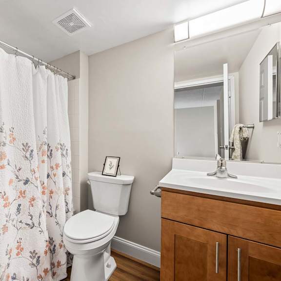 a white toilet sits next to a white sink in a bathroom.