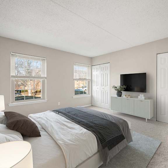 a bedroom with a large bed and a flat screen tv.
