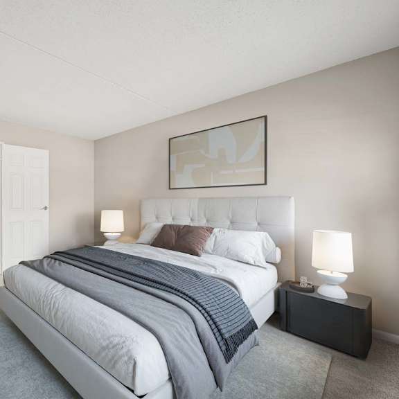 a bedroom with a large bed and a painting on the wall.