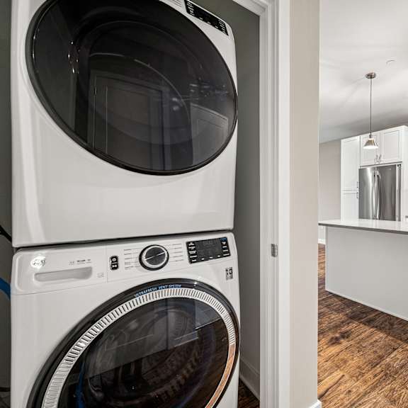 a white washing machine in a laundry room.
