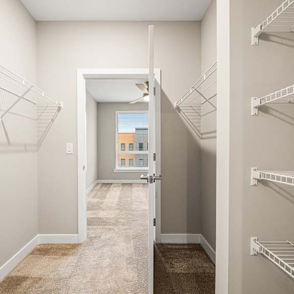 a hallway with a doorway leading to a balcony.