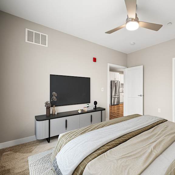 a bedroom with a large bed and a flat screen tv.