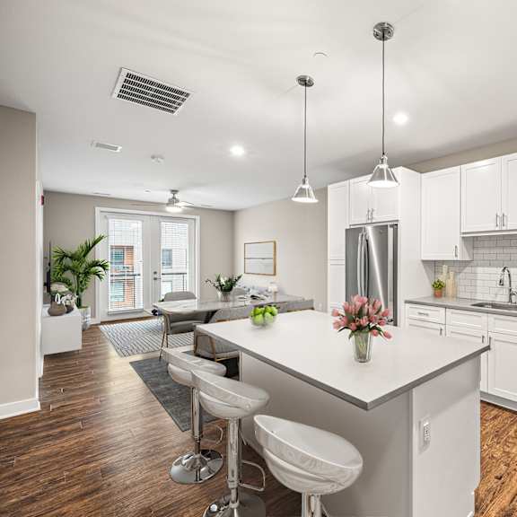 a modern kitchen with white cabinets and a center island.