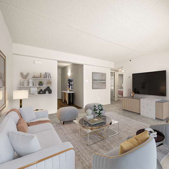 a modern living room with a white sofa, a coffee table, and a television.