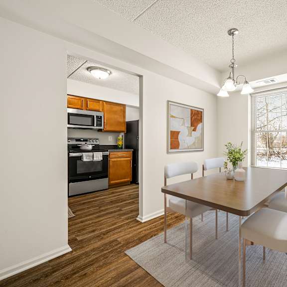 a modern kitchen with a dining table and chairs.