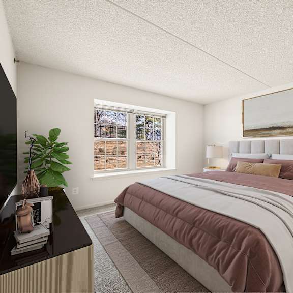 a bedroom with a large bed and a window overlooking a snowy landscape.