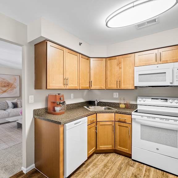 a kitchen with wooden cabinets and white appliances.