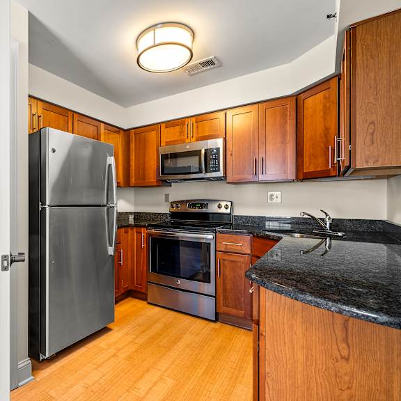a modern kitchen with a washer and dryer built into the cabinetry.