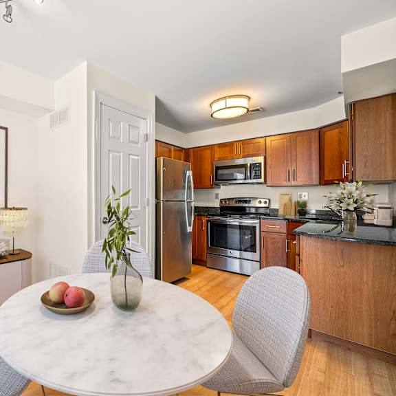 a modern kitchen with a dining table set for two.