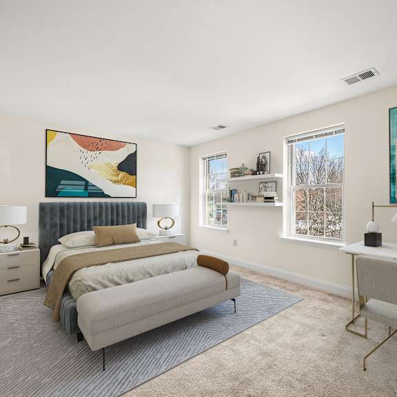 a bedroom with a bed, a desk, and a painting on the wall.