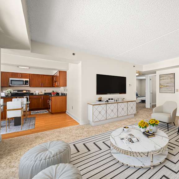 a living room with a white couch, a coffee table, and a television.