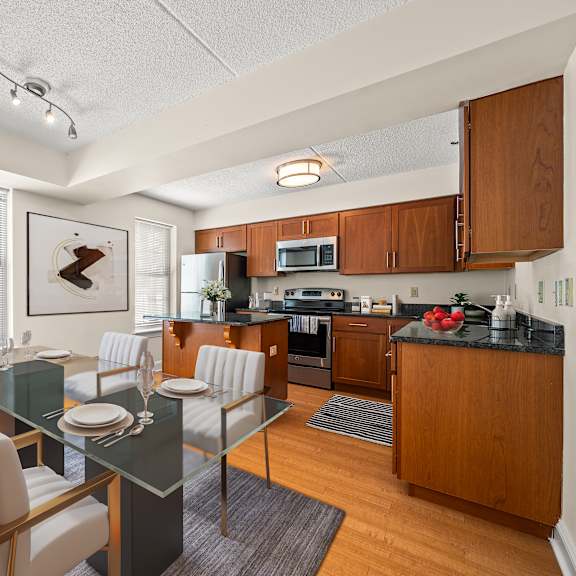 a modern kitchen with a dining table set for two.